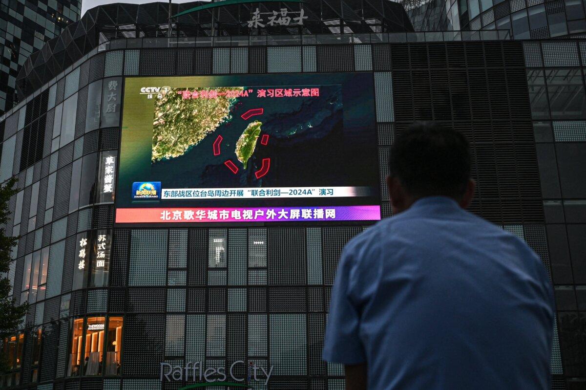 An outdoor screen shows news coverage of China's military drills around Taiwan, in Beijing on May 23, 2024. (Jade Gao/AFP via Getty Images)