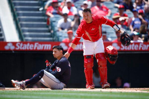 Andrés Giménez (0) of the Cleveland Guardians after hit by a pitch in front of Matt Thaiss (21) of the Los Angeles Angels in the third inning in Anaheim, Calif., on May 26, 2024. (Ronald Martinez/Getty Images)