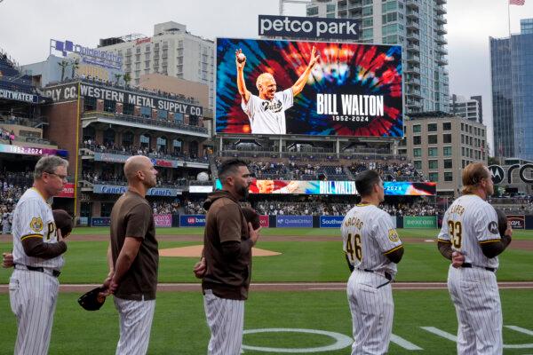 Members of the Padres stand during a moment of silence for basketball Hall of Famer Bill Walton before a game against the Marlins in San Diego on May 28, 2024. (Gregory Bull/AP Photo)