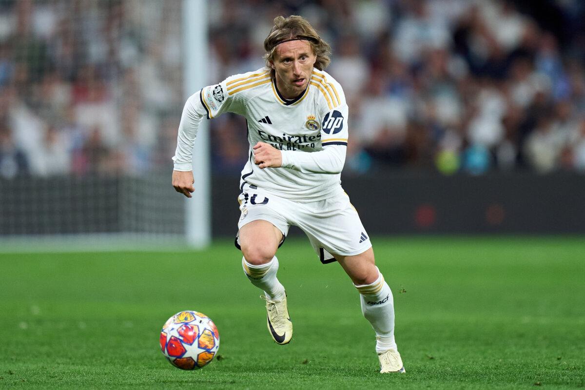 Luka Modric of Real Madrid runs with the ball during the UEFA Champions League quarterfinal first leg match between Real Madrid CF and Manchester City at Estadio Santiago Bernabeu in Madrid, Spain, on April 9, 2024. (Angel Martinez/Getty Images)