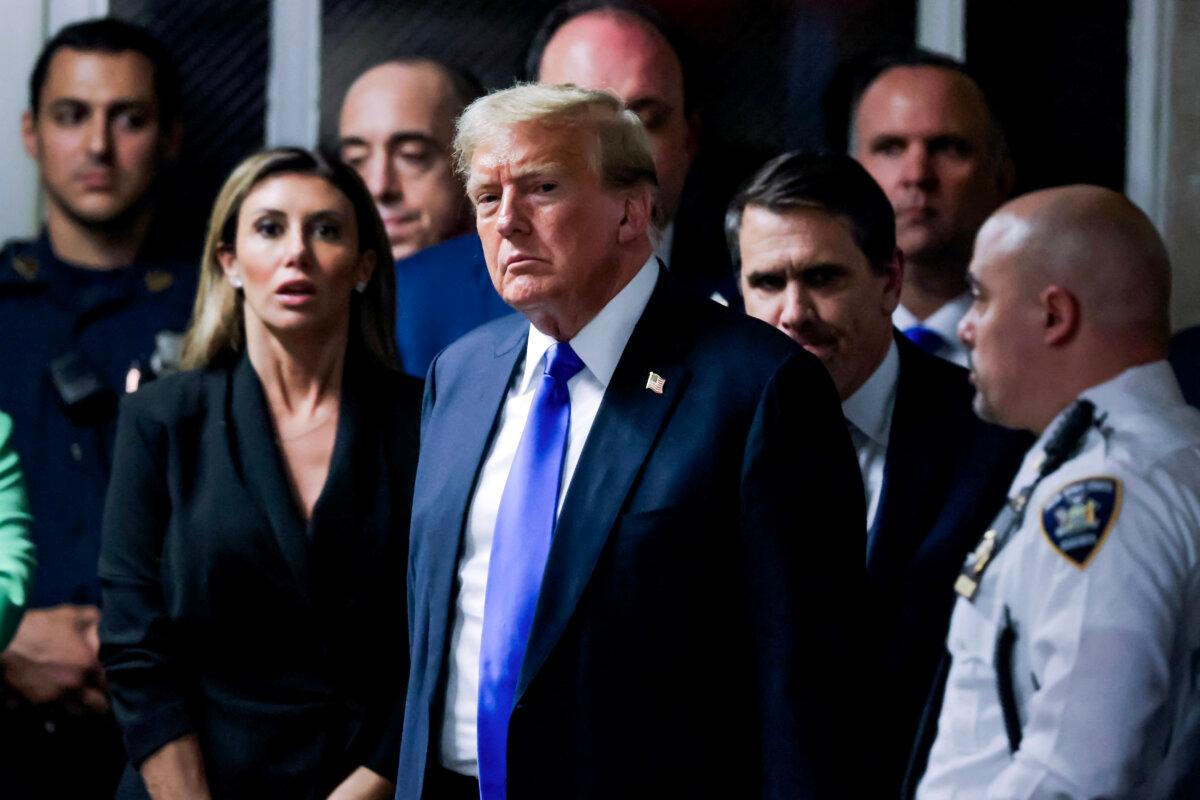 Former President and Republican presidential candidate Donald Trump stands surrounded by his legal team as he exits the courtroom after he was convicted in his criminal trial at Manhattan Criminal Court in New York City on May 30, 2024. (Justin Lane/Pool/AFP via Getty Images)