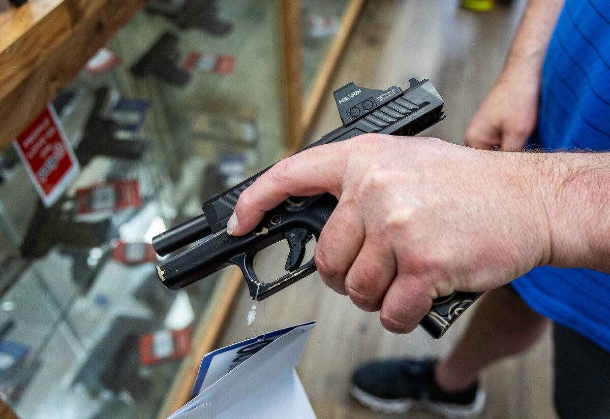 Customers shop for firearms in San Diego on May 30, 2024. (John Fredricks/The Epoch Times)