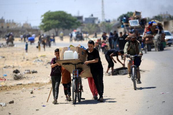 Palestinians transport their belongings as they flee the area of Tel al-Sultan in Rafah in the southern Gaza Strip on May 30, 2024. (Eyad Baba/AFP via Getty Images)