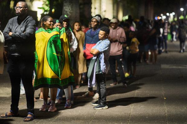 Voters wait in line at night outside the city hall voting station in Durban on May 29, 2024. South Africans vote on May 29, 2024, in what may be the most consequential election in decades. (Zinyange AuntonyY/AFP via Getty Images)