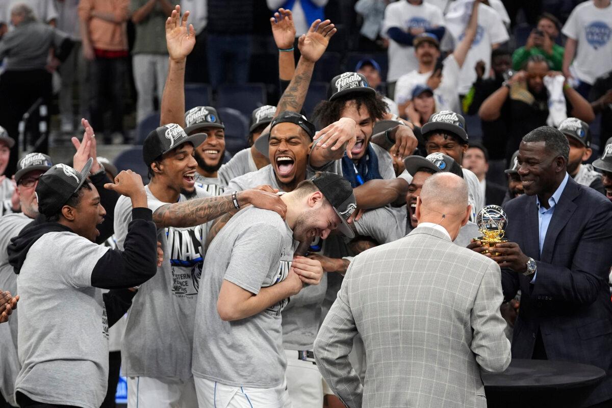 Dallas Mavericks guard Luka Doncic (C) celebrates with teammates after Game 5 of the Western Conference finals in the NBA basketball playoffs in Minneapolis on May 30, 2024,. (Abbie Parr/AP Photo)