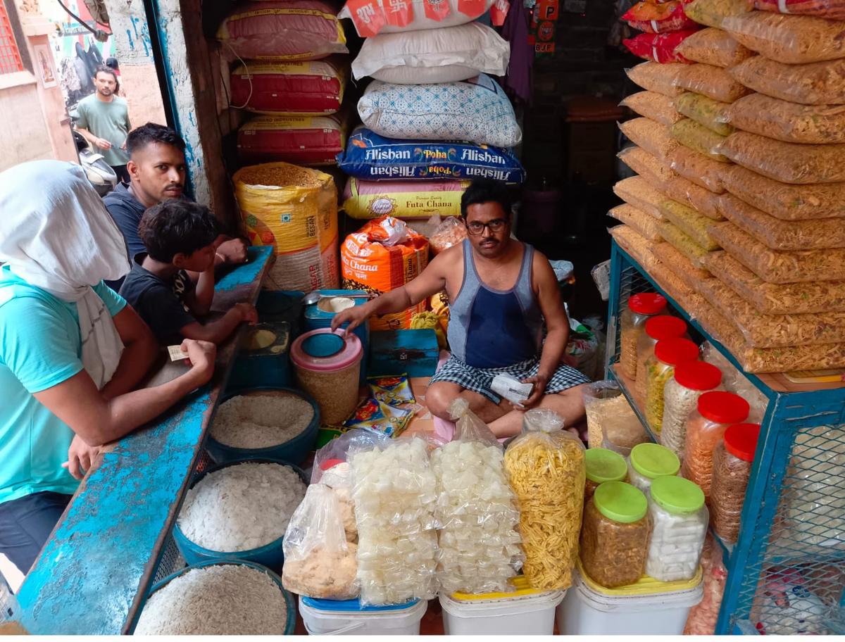 Voter Dilip Kumar, 45, a local savory seller, sits at his shop on June 1, 2024. (Venus Upadhayaya/The Epoch Times)