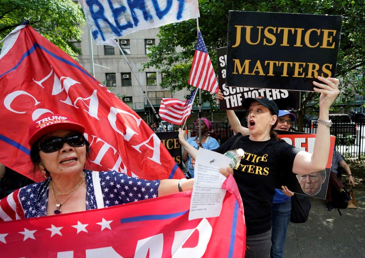 Supporters and opponents of Republican presidential candidate and former President Donald Trump scuffle as they wait for a verdict in Trump's hush money criminal trial outside Manhattan Criminal Court in New York City on May 29, 2024. (Timothy A. Clary/AFP via Getty Images)