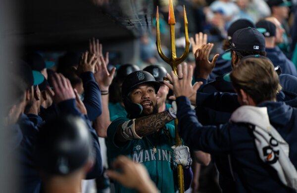 J.P. Crawford (30 of the Seattle Mariners celebrates in the dugout after hitting a grand slam home run during the fourth inning of a game against the Los Angeles Angels in Seattle on June 1, 2024. (Stephen Brashear/Getty Images)