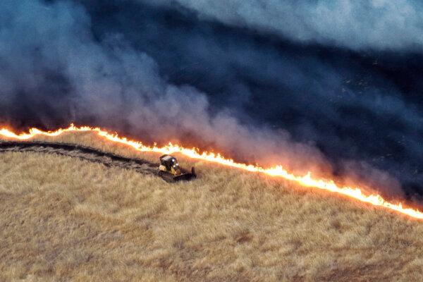 This photo released by the California Department of Forestry and Fire Protection shows a bulldozer working against the Corral Fire near Tracy, Calif., on June 2, 2024. (California Department of Forestry and Fire Protection via AP)