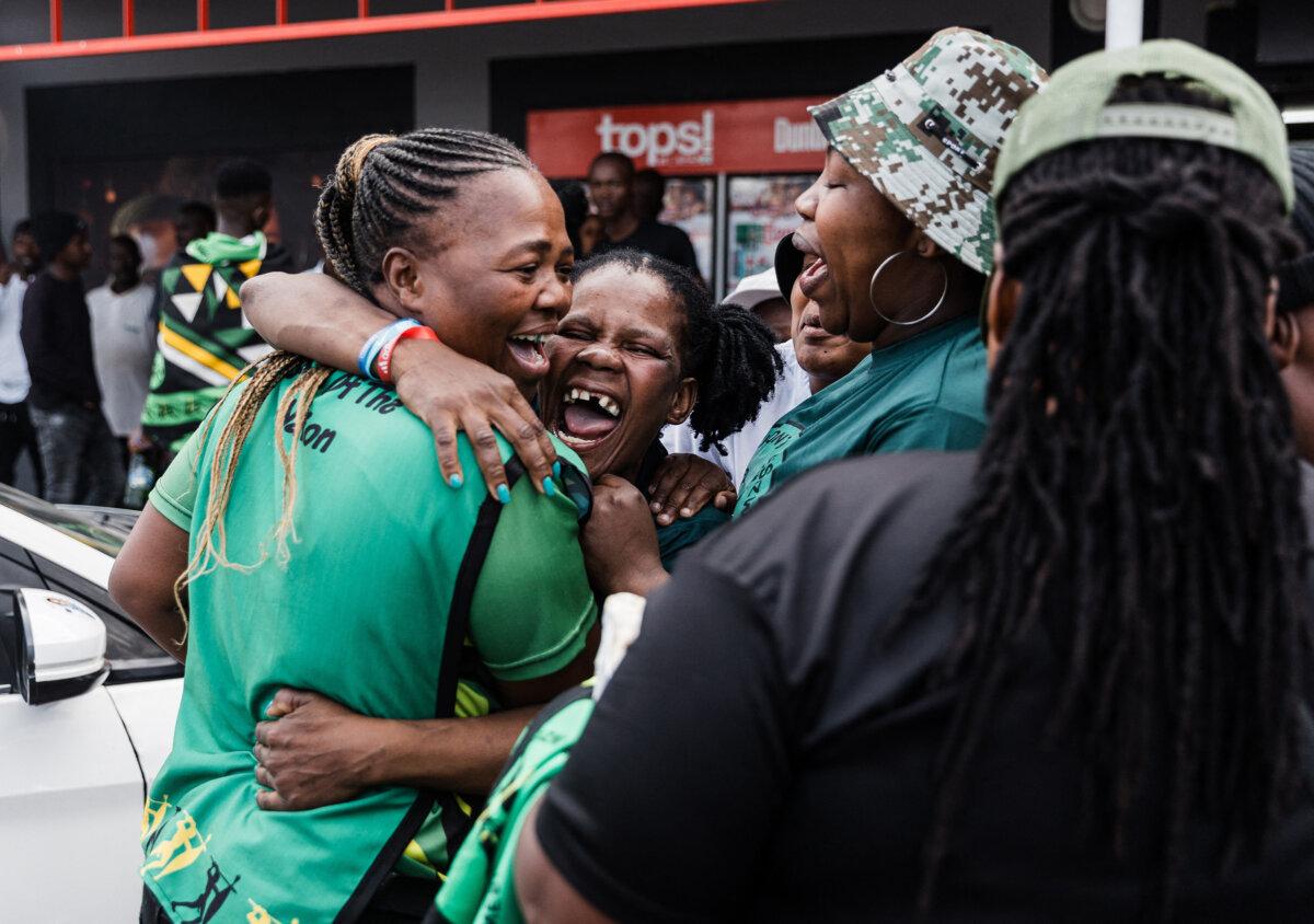 Supporters of the newly formed uMkhonto weSizwe (MK) party hug and chant slogans as hundreds of supporters gather to celebrate in Kwaximba on June 2, 2024. (Rajesh Jantilal/AFP via Getty Images)