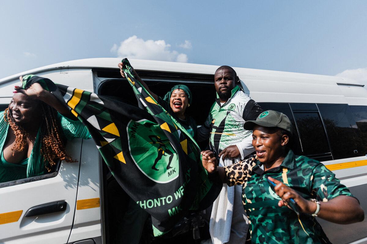 Supporters of former president Jacob Zuma's newly formed uMkhonto weSizwe (MK) party hold flags and chant slogans as hundreds of supporters gather to celebrate their leader's surprise comeback on June 2, 2024. (Rajesh Jantilal/AFP via Getty Images)