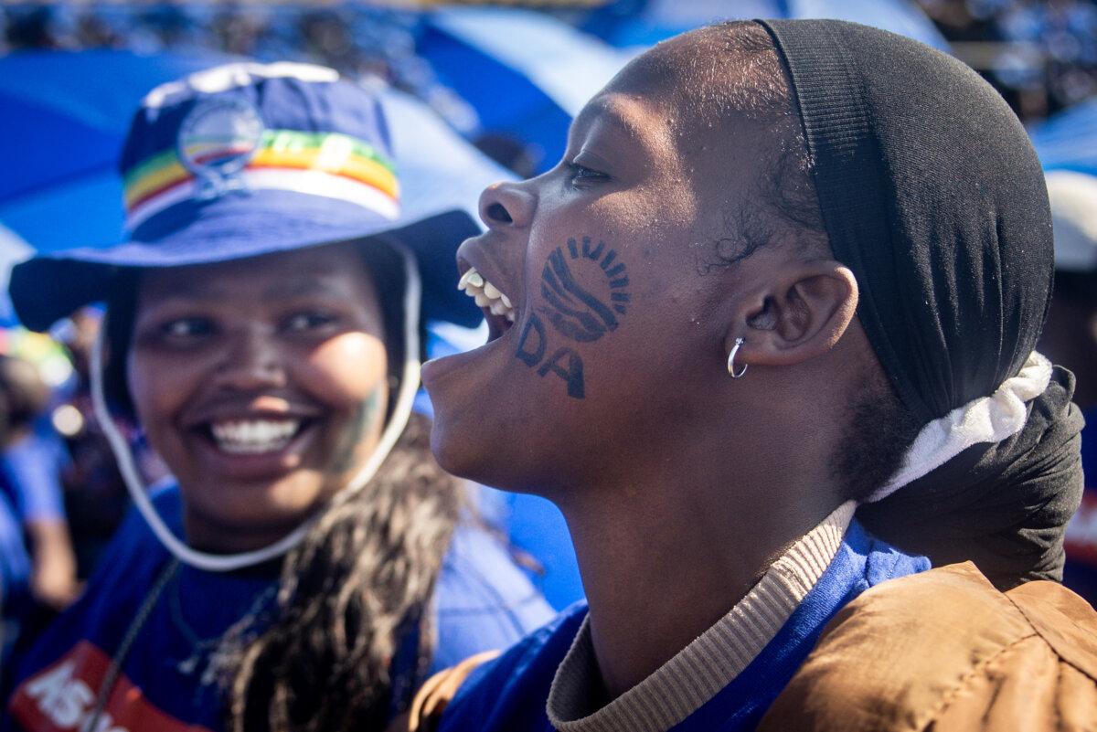 Democratic Alliance (DA) supporters chant slogans and sing songs as they wait for DA leader John Steenhuisen before the start of the final DA election rally held in Willowmoore Stadium, Benoni, on May 26, 2024, in Johannesburg, South Africa. (Chris McGrath/Getty Images)