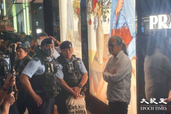 Sanmu Chen was taken away by the police less than five minutes after he appeared in Causeway Bay, Hong Kong on June 3. (Sheung Yu Cheuk/The Epoch Times)