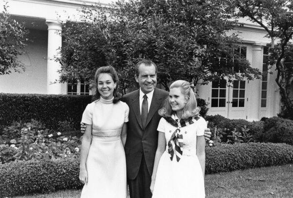 Richard Nixon and his daughters (L) Julie Nixon Eisenhower and Tricia Nixon on Father's Day, June 15, 1969. (Nixon White House Photographs/Public Domain)