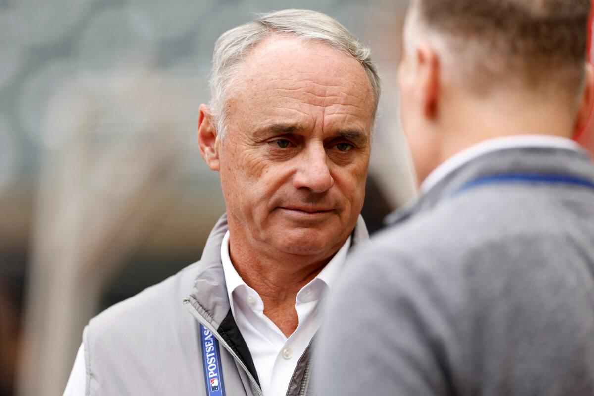 Major League Baseball Commissioner Robert D. Manfred Jr. talks prior to game 2 of the Wild Card Series between the Toronto Blue Jays and the Minnesota Twins at Target Field in Minneapolis, Minn., on Oct. 4, 2023. (David Berding/Getty Images)