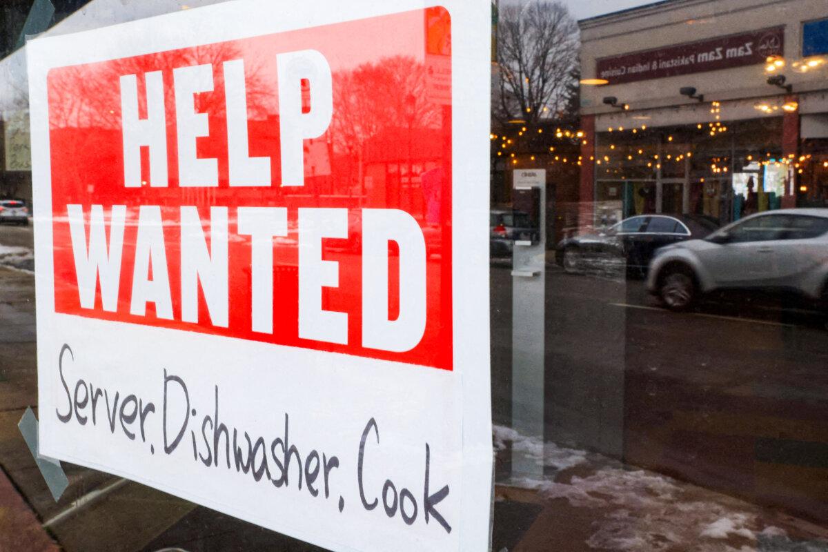 A “Help Wanted” sign hangs in a restaurant window in Medford, Mass., on Jan. 25, 2023. (Brian Snyder/Reuters)