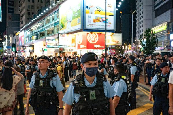 Police officers patrol Hong Kong's Causeway Bay district near Victoria Park where people traditionally gathered annually to mourn the victims of China's Tiananmen Square crackdown in 1989 on June 4, 2024. Since the new national security law has gone into effect, the event no longer takes place. (Anthony Kwan/Getty Images)