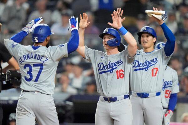 Los Angeles Dodgers' Teoscar Hernández (37) celebrates with teammates Will Smith (16), Mookie Betts (50) and Shohei Ohtani (17), after hitting a grand slam during the eighth inning of a baseball game against the New York Yankees in New York on June 8, 2024. (Frank Franklin II/AP Photo)