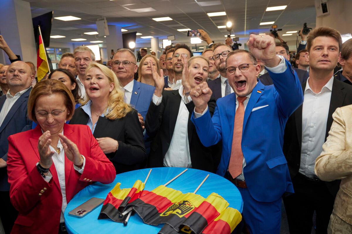 Alice Weidel (C) and Tino Chrupalla (2nd R), both AfD federal chairmen, cheer at the AfD party headquarters during the forecast for the European elections, in Berlin on June 9, 2024. (Joerg Carstensen/dpa via AP)