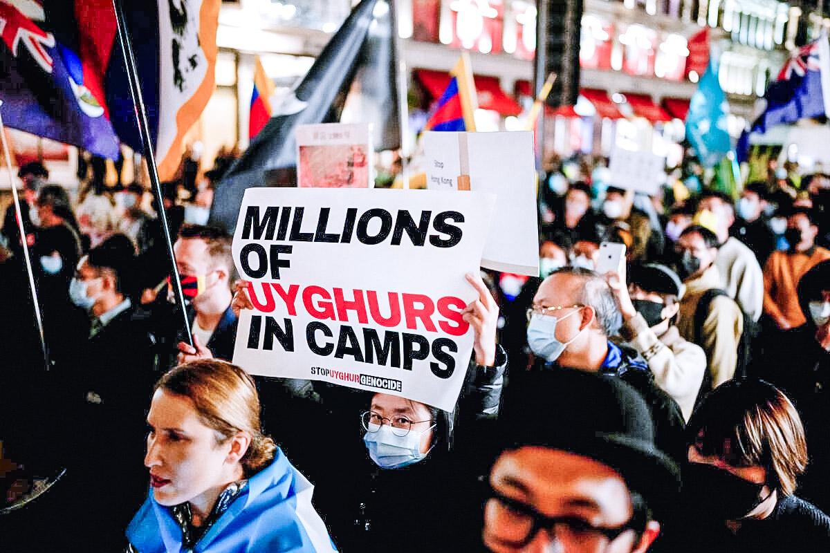 Demonstrators supporting Uyghurs, Tibetans, and Hongkongers take part in a protest against the Chinese Communist Party as they march along Regent Street toward the Chinese Embassy in London on Oct. 1, 2021. (Matt Dunham/AP Photo)