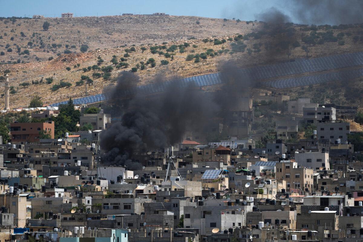 Smoke rises in the Palestinian Al Fara'a refugee camp in the occupied West Bank following an Israeli military raid on June 10, 2024. (Majdi Mohammed/AP Photo)