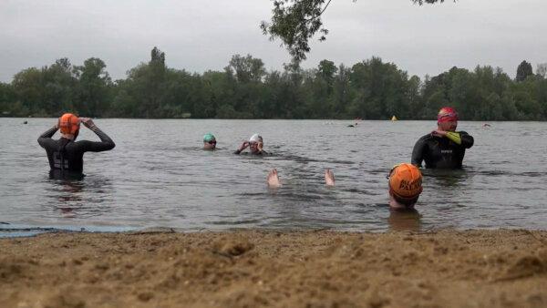 People protesting at sewage overflows take part in an open swim at Ferris Meadow Lake in Shepperton, Surrey on May 18, 2024. (Elena Giuliano/PA Wire}