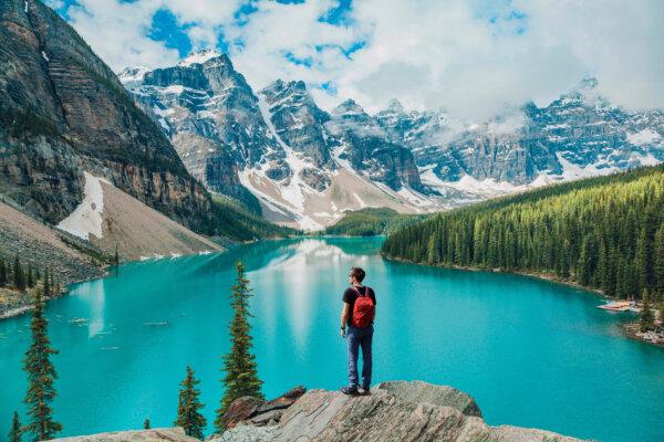 A hiker takes in the view at Moraine Lake, located in Banff National Park, Alberta. (Maridav/Shutterstock)