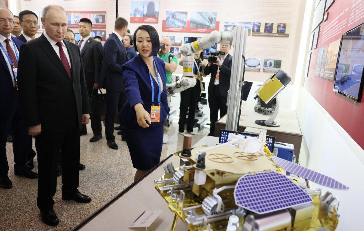 In this pool photograph distributed by the Russian state agency Sputnik, Russia's President Vladimir Putin tours a Russia-China trade expo in the northeastern city of Harbin on May 17, 2024. (Mikhail Metzel/POOL/AFP via Getty Images)
