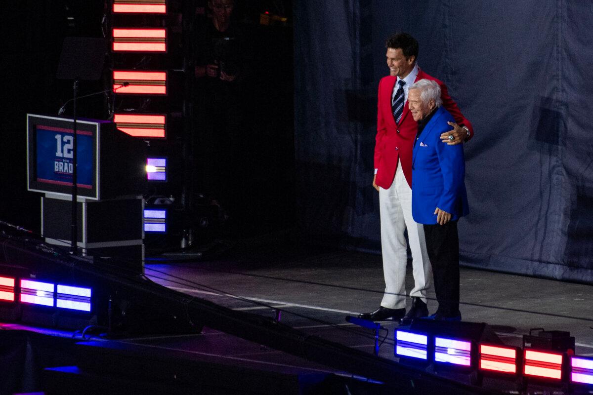 CEO of the New England Patriots Robert Kraft (R) stands with former New England Patriots quarterback Tom Brady, wearing his red Patriots Hall of Fame induction jacket, during the 2024 induction ceremony at Gillette Stadium in Foxborough, Mass., on June 12, 2024. (Joseph Prezioso/AFP via Getty Images)