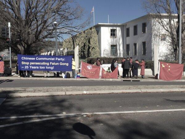 Falun Gong practitioners and pro-CCP protestors are seen holding banners and flags ahead of CCP Premier Li Qiang's visit to Canberra, Australia, on June 16, 2024. (The Epoch Times)