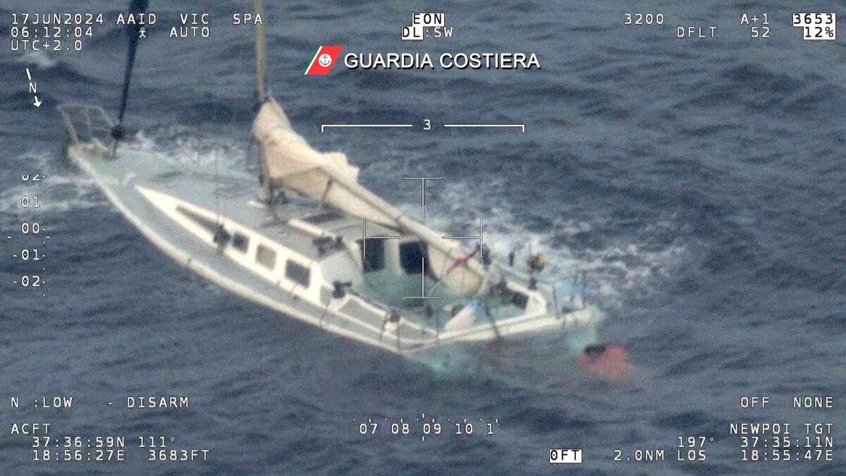 A sail boat used by migrants half sinks in the Mediterranean Sea between Italy and Greece early on June 17, 2024. (Italian Coast Guard via AP, Ho)