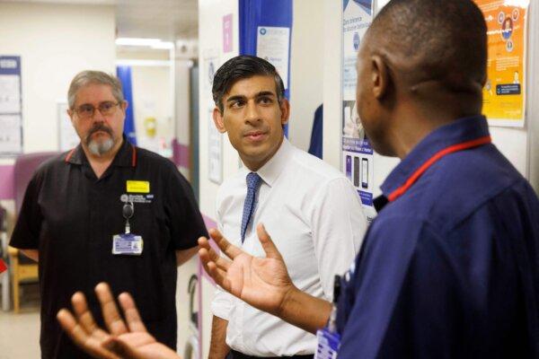Prime Minister Rishi Sunak (C) meets with staff as he tours Moorfields Eye Hospital in London on Oct. 26, 2023. (Jamie Lorriman/Pool/AFP via Getty Images)