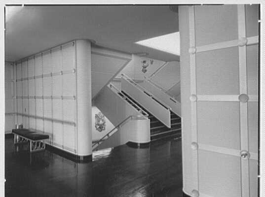 An onboard stairway, with an aluminum sculpture of the Great Seal of the United States on each landing. (Public Domain)