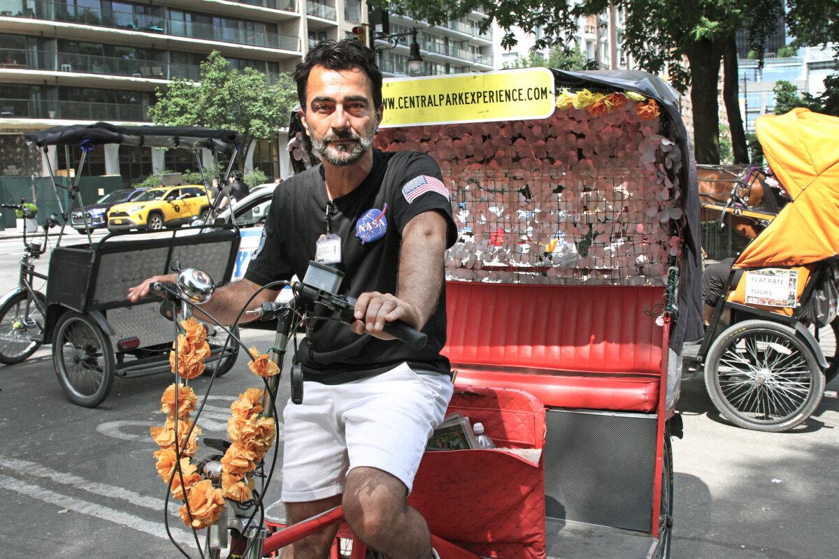 Omer Biyi of Central Park Experience operates his pedicab in Central Park, New York City, on June 19, 2024. (Richard Moore/The Epoch Times)
