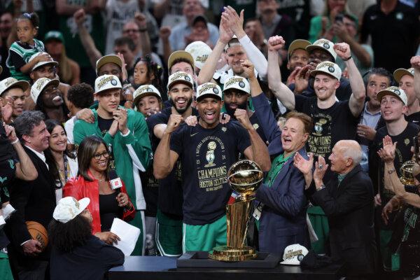 Jayson Tatum (0), Al Horford (42), Jaylen Brown (7) of the Boston Celtics celebrate after Boston's 106-88 win against the Dallas Mavericks in Game Five of the 2024 NBA Finals in Boston on June 17, 2024. (Adam Glanzman/Getty Images)