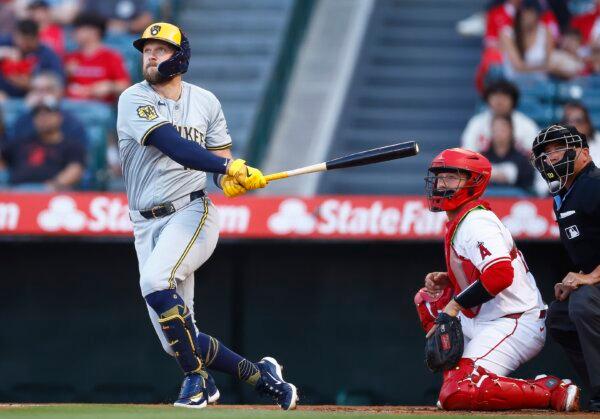 Rhys Hoskins (12) of the Milwaukee Brewers hits a sacrifice fly against the Los Angeles Angels in the first inning in Anaheim, Calif., on June 19, 2024. (Ronald Martinez/Getty Images)