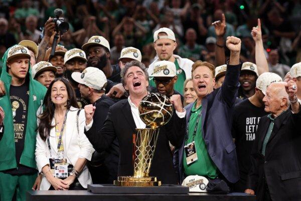 Majority owner Wyc Grousbeck of the Boston Celtics celebrates with the Larry O’Brien Championship Trophy after Boston's 106-88 win against the Dallas Mavericks in Game Five of the 2024 NBA Finals in Boston on June 17, 2024. (Elsa/Getty Images)