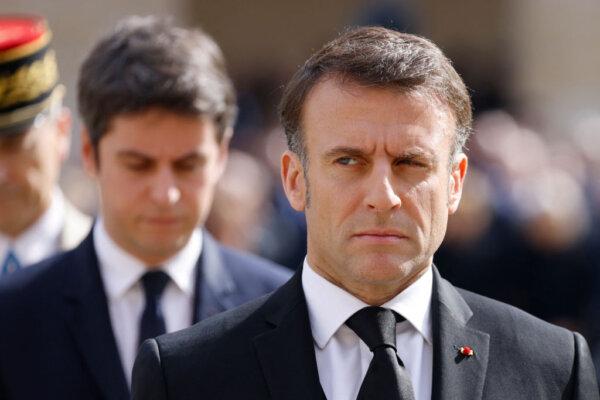 France's President Emmanuel Macron (R) looks on, flanked by France's Prime Minister Gabriel Attal (L) at the Hotel des Invalides in Paris on March 20, 2024. (Ludovic Marin/AFP via Getty Images)