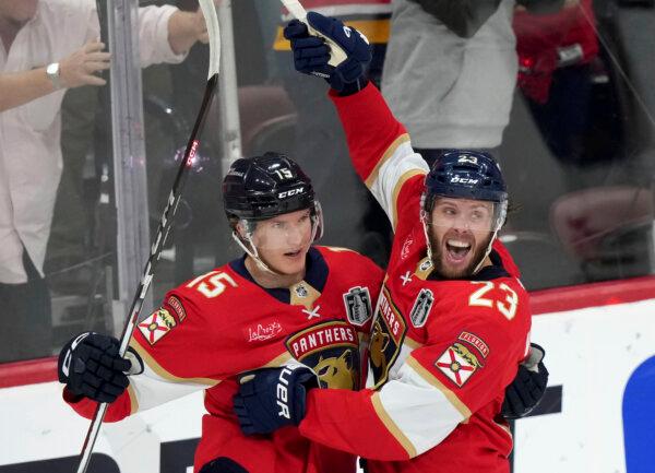 Florida Panthers forward Carter Verhaeghe (23) celebrates his goal with teammate Anton Lundell (15) after scoring on the Edmonton Oilers during the first period of Game 7 of the Stanley Cup Final in Sunrise, Fla., on June 24, 2024. (Nathan Denette/The Canadian Press via AP)