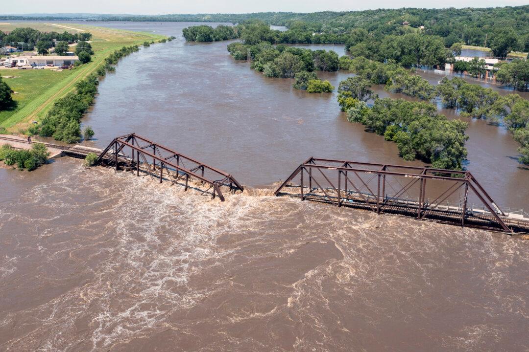 Midwestern Flooding Collapses Bridge, Forces Evacuations and Kills at Least 2