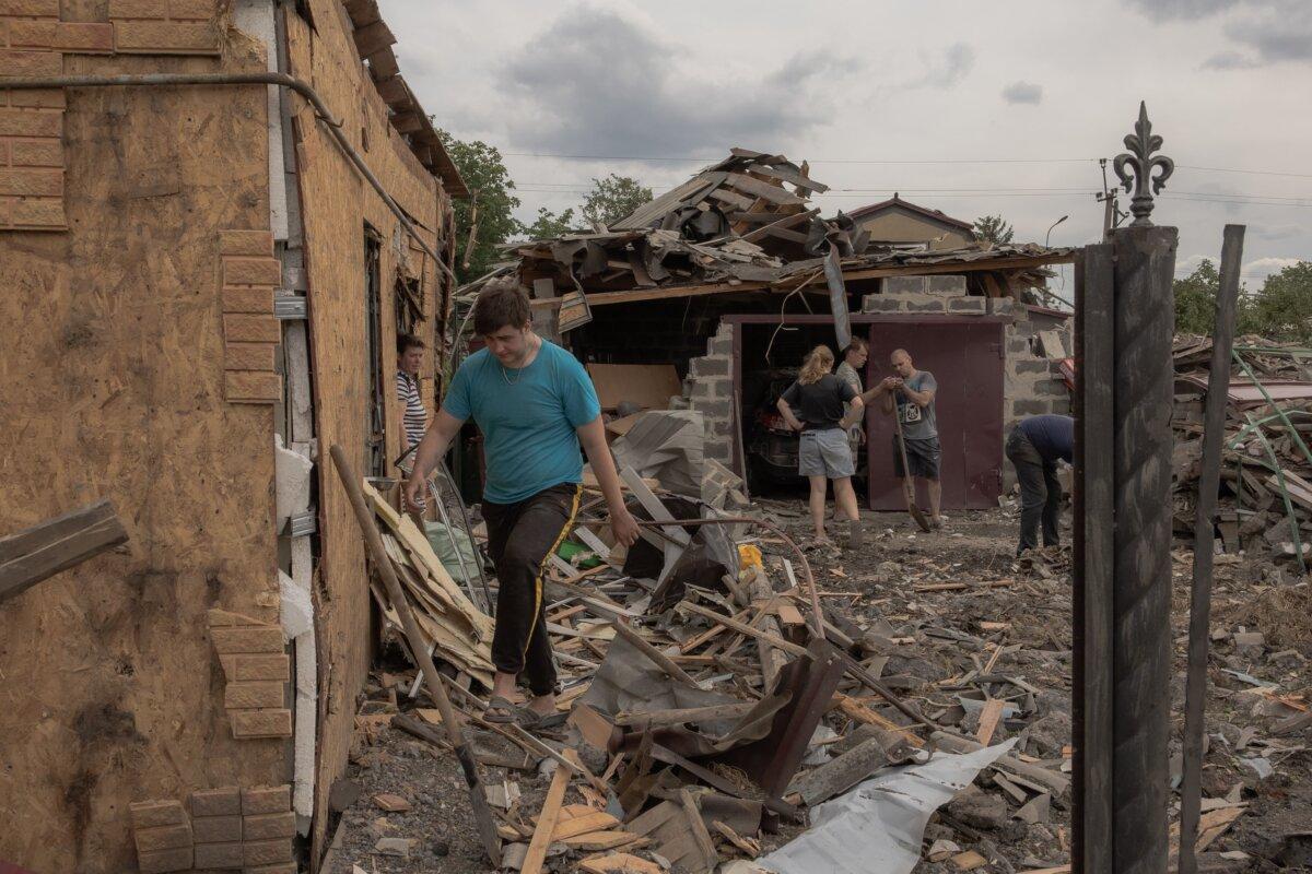 Residents clean debris next to heavily damaged houses following shelling in Pokrovsk, in the eastern Donetsk region of Ukraine, on June 24, 2024. (Roman Pilipey/AFP via Getty Images)