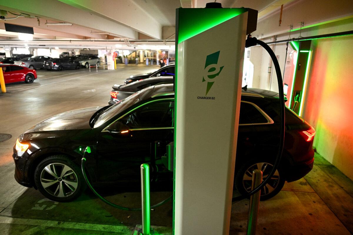 An electric Audi sports utility vehicle (SUV) charges at a public Electrify America EV DC fast charger in Los Angeles, California on May 16, 2024. (Patrick T. Fallon / AFP)