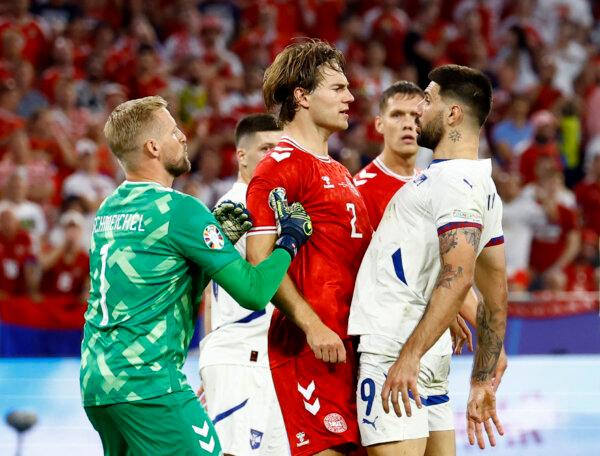Serbia's Aleksandar Mitrovic remonstrates with Denmark's Joachim Andersen as Kasper Schmeichel looks on on June 25, 2024. (Michaela Stache/Reuters)