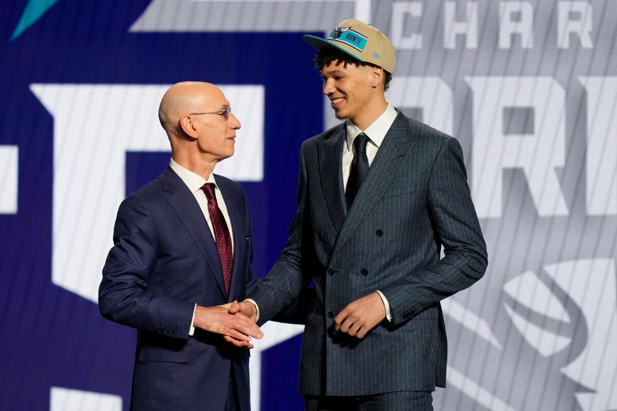 Tidjane Salaun, right, greets NBA commissioner Adam Silver after being selected by the Charlotte Hornets as the sixth pick during the first round of the NBA basketball draft in New York on June 26, 2024. (Julia Nikhinson/AP Photo)