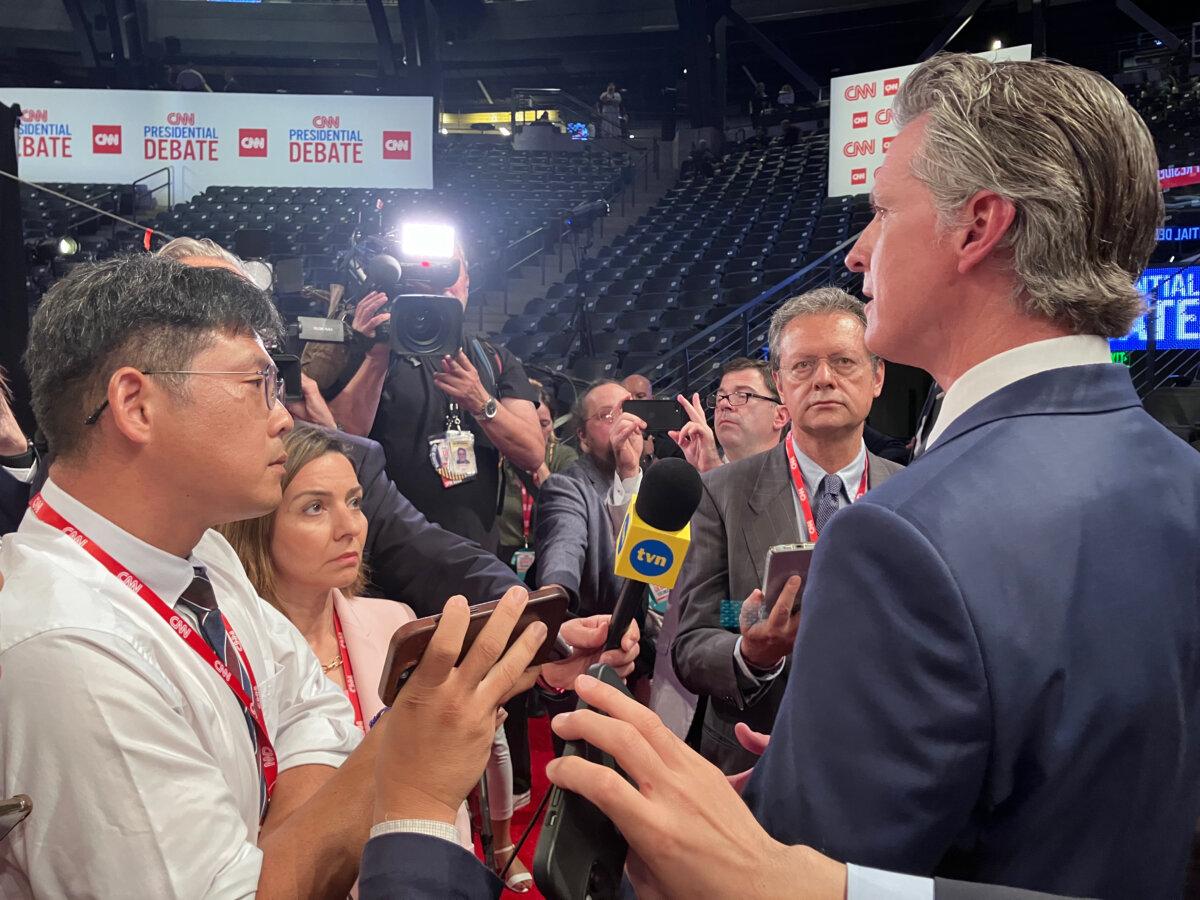 California Gov. Gavin Newsom speaks to reporters at Georgia Tech’s McCamish Pavilion near the site where President Joe Biden and former President Donald Trump will debate in Atlanta, Ga., on June 27, 2024. (Janice Hisle/The Epoch Times)