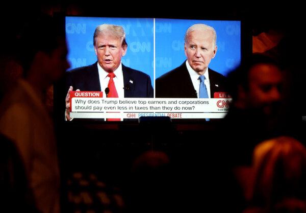 People watch the CNN presidential debate between U.S. President Joe Biden and Republican presidential candidate former President Donald Trump at The Continental Club in Los Angeles, Calif., on June 27, 2024. (Mario Tama/Getty Images)