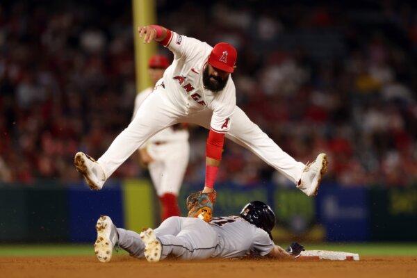 Luis Guillorme (15) of the Los Angeles Angels jumps to make the out against Riley Greene (31) of the Detroit Tigers during the ninth inning in Anaheim, Calif., on June 29, 2024. (Katelyn Mulcahy/Getty Images)