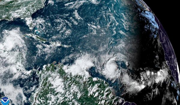 A satellite image shows Hurricane Beryl (lower center R) as it strengthens over the Atlantic Ocean and churns toward the southeast Caribbean at 4:20 p.m. ET on June 29, 2024. (NOAA via AP)