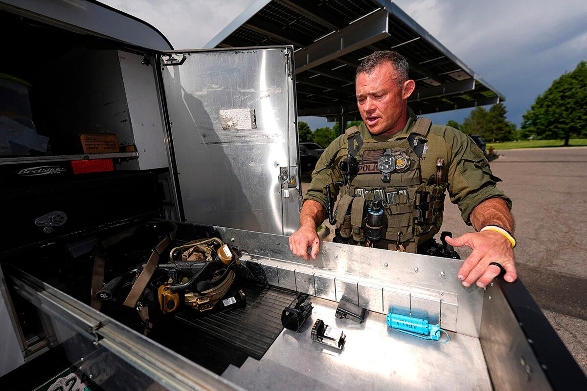 Denver Police Department Sgt. Justin Dodge surveys his gear in south Denver on June 12, 2024. (David Zalubowski/AP Photo)