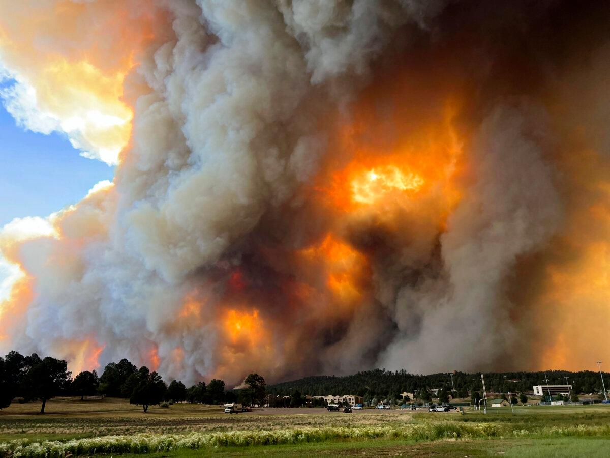 Smoke rises from fires in Ruidoso, N.M., on June 17, 2024. The fires left burn scars that have contributed to flash flooding. (Pam Bonner via AP)